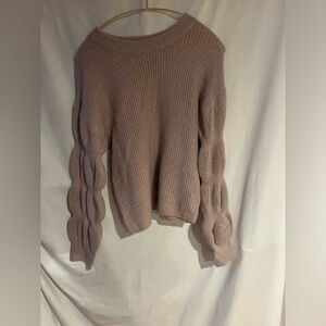 And now this, pink knitted sweater, ruffled sleeved